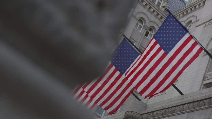 Flags are displayed on a government building