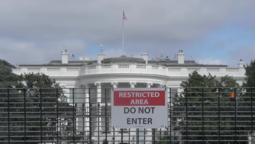 Camera is focused on the white house with a restricted sign in front