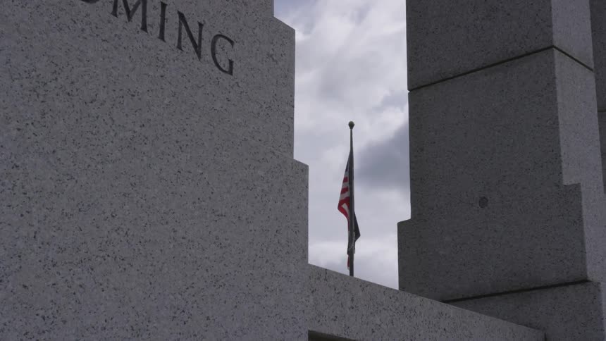 A flag is displayed on a government building