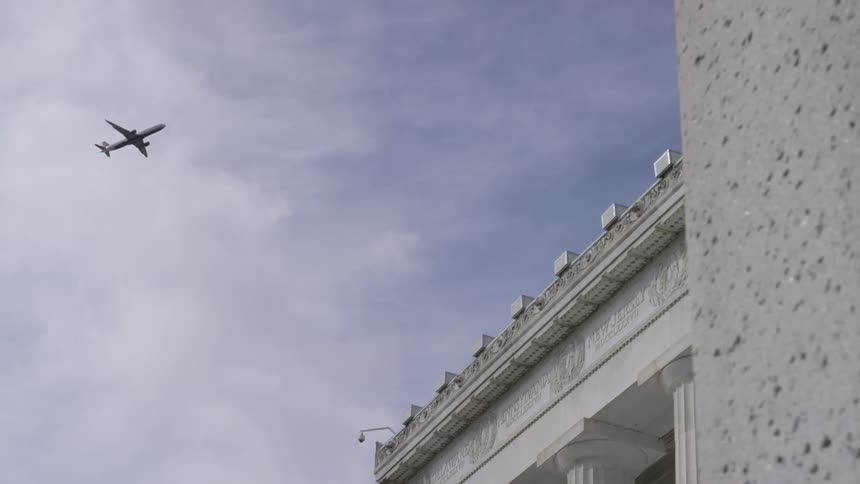 A plane flying over a building