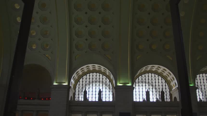 Double glass doors open up to show arched windows and an ornate curved ceiling with gold circles