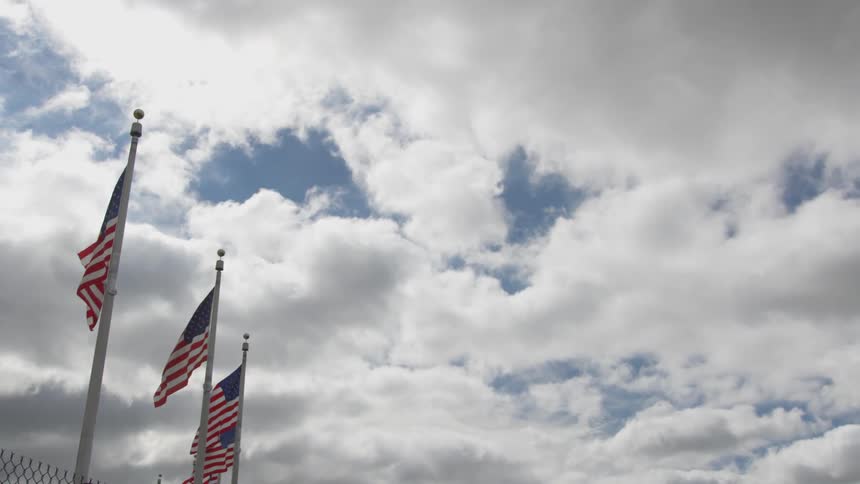 A cloudy sky over american flags
