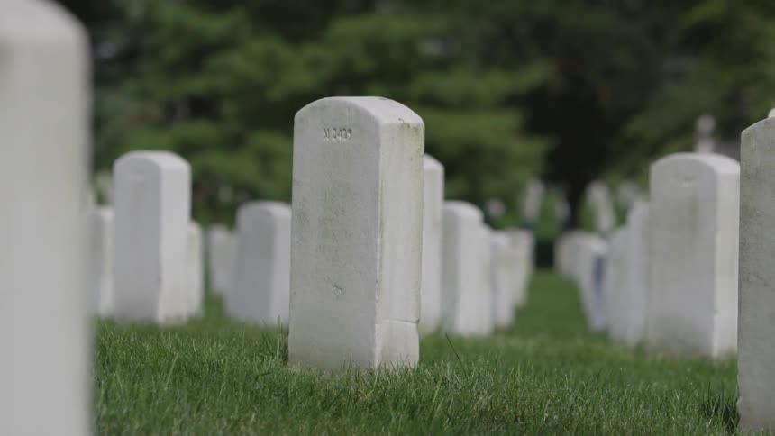 Tombstones in a large cemetery outdoors