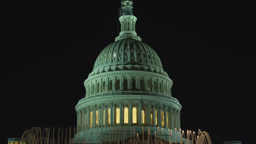 The dome and spire of the united states capitol building during the night