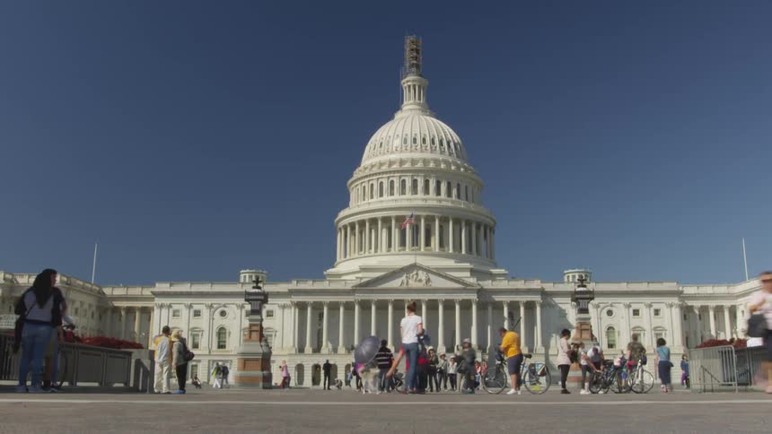 Tourists taking photos of a large government building