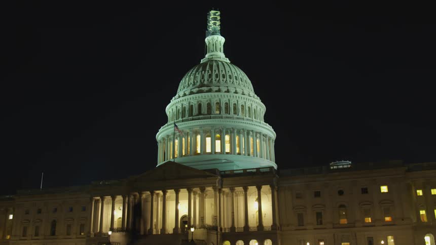 The united states capitol building lit up at night time