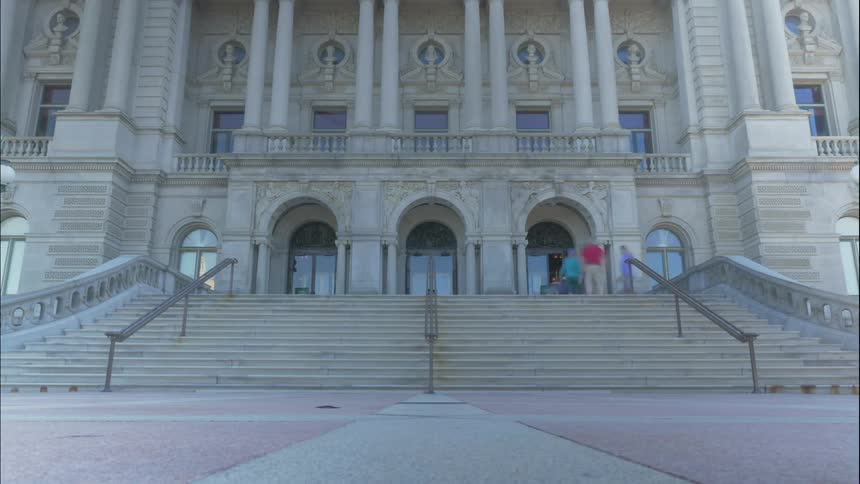 People walking into building