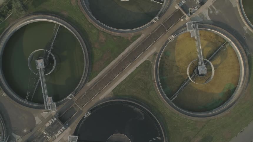 A causeway connects giant tanks of water