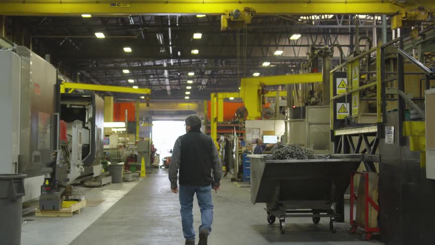 A man walking through a factory