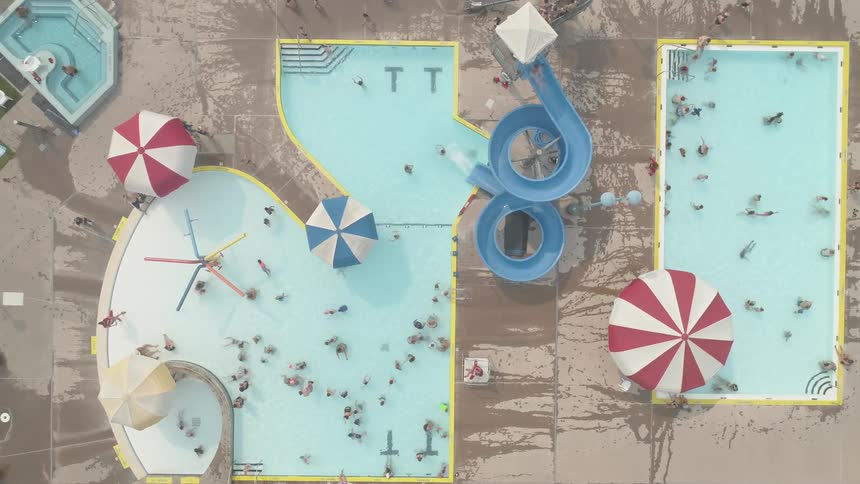 Camera looks down into two swimming pools
