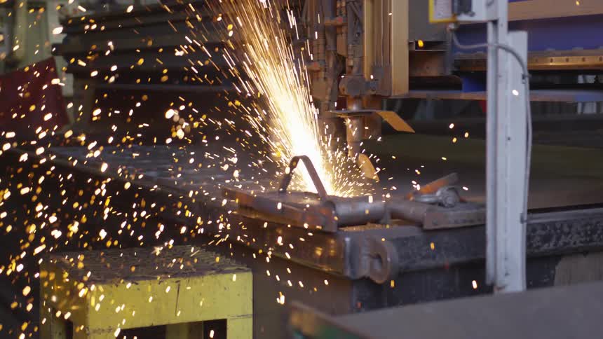 Sparks fly in workshop as machine works on metal