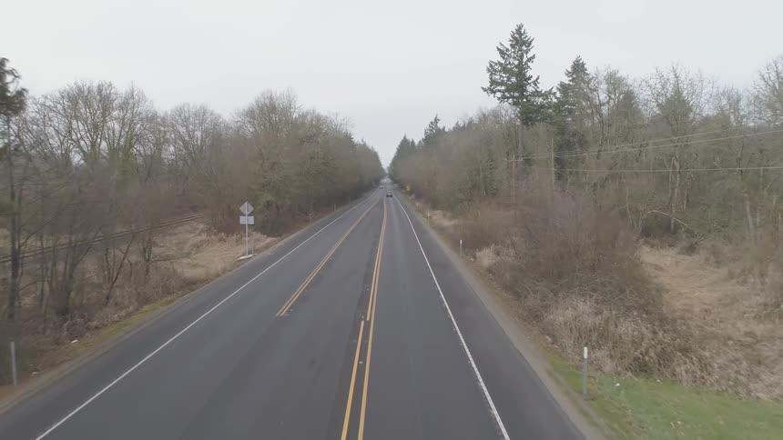 Camera flies down a road