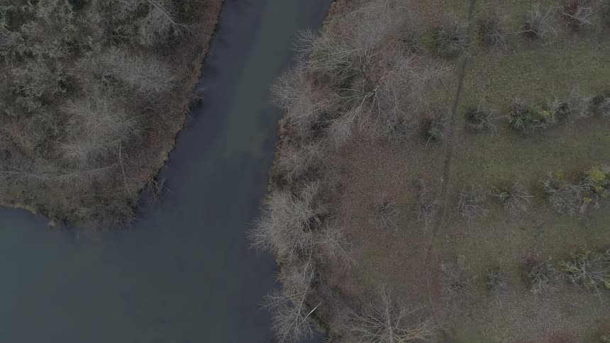Camera looks down on a river and trees