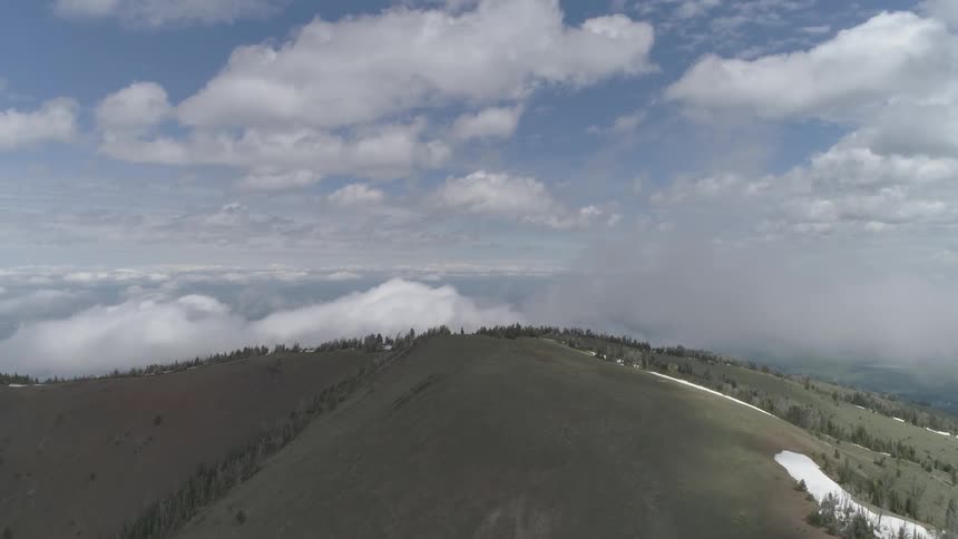 Landscape of mountain slope with sky filled with clouds during the day