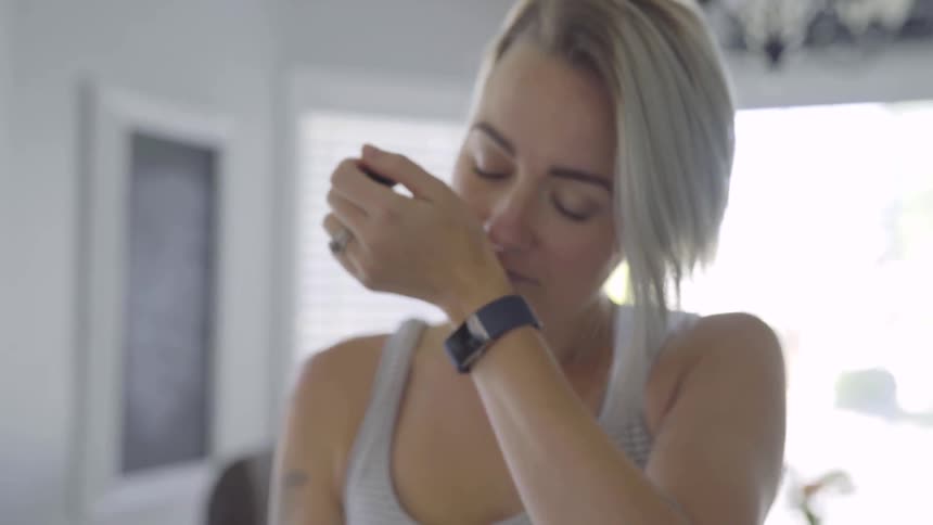 Girl sniffing her wrist after applying oil