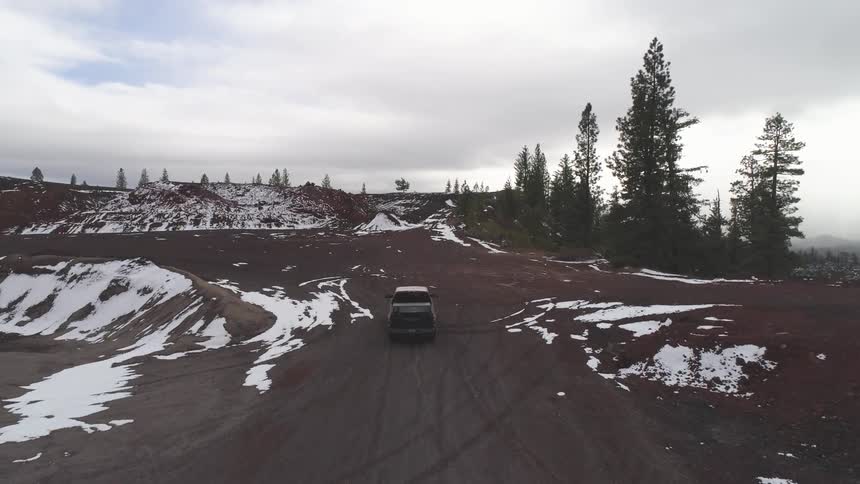 A truck drives down a mountain pass