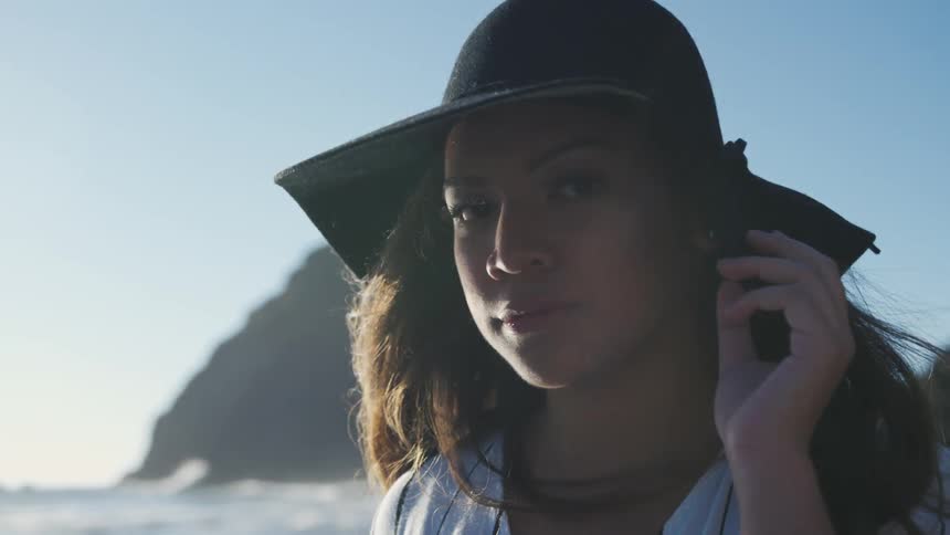 A young woman wearing a hat outdoors