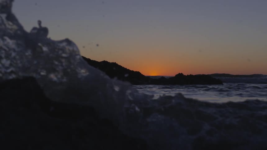 Waves crashing on a rocky shore dawn