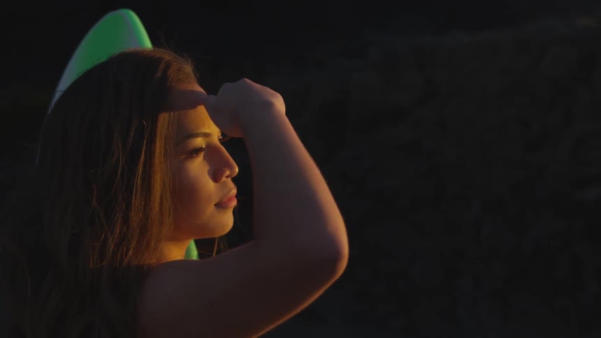 A woman using her hand to shield light
