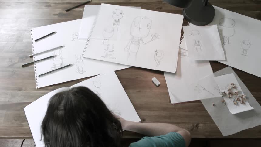 Person drawing at a large table