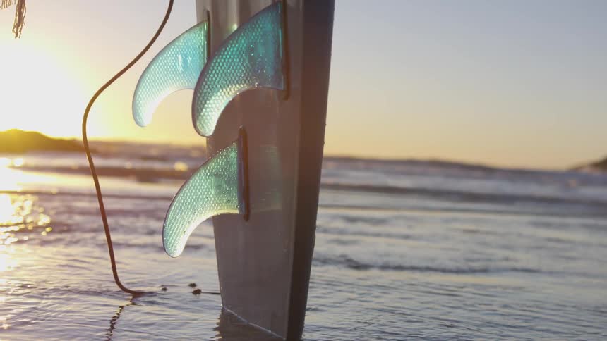 A surfboard is in the ocean