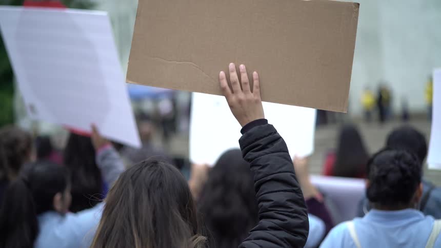 A group of people are protesting outside
