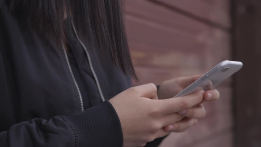 Woman texts on phone