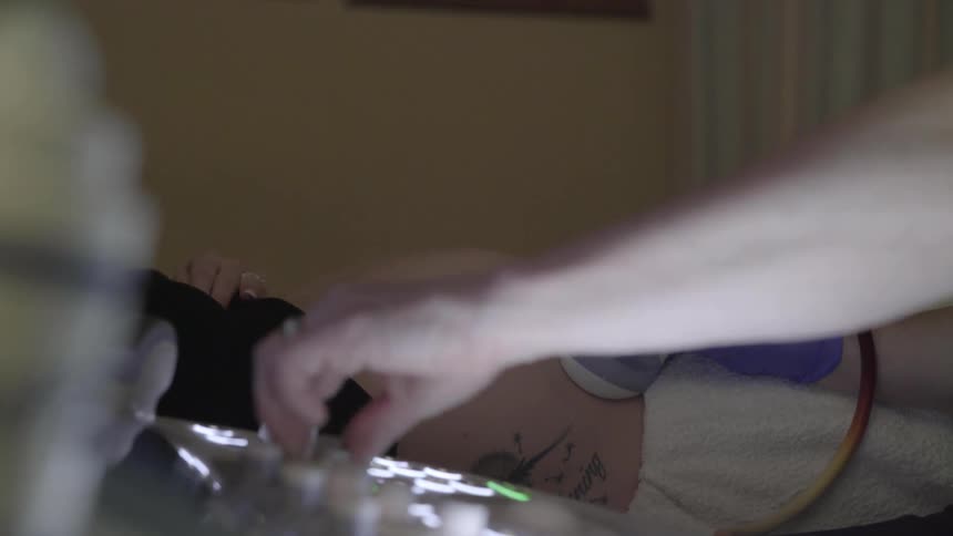 A person turning dials on a ultrasound
