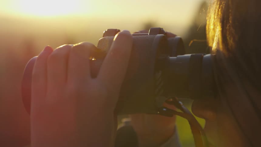 Girl looking through binoculars