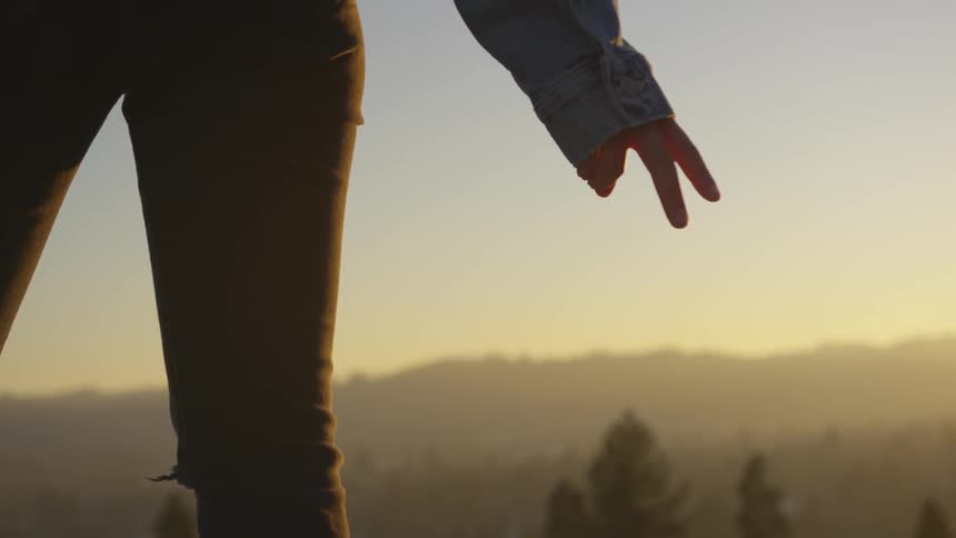 Person stands looking over valley