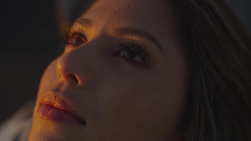 A woman is laying down staring up
