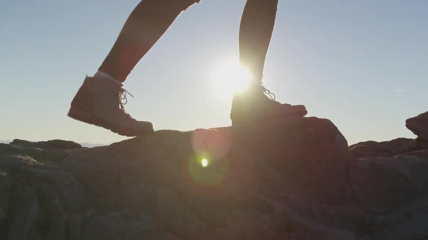 A person is walking on a cliff