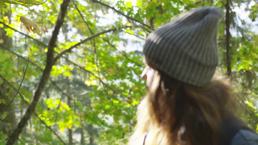 A woman is walking in a forest area