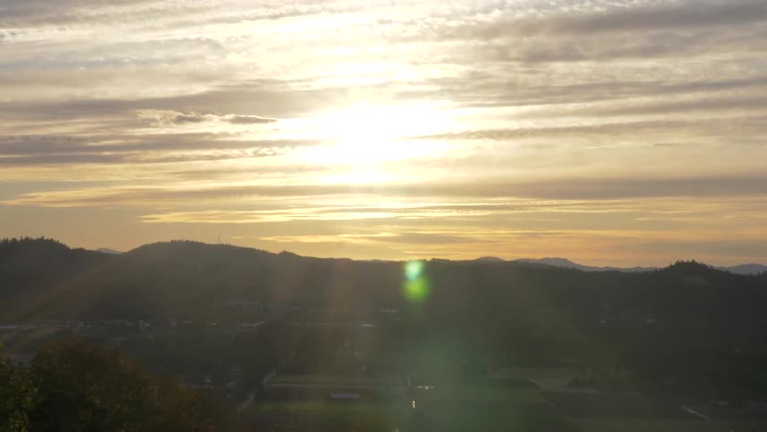 A landscape view looking over a field and towards mountains