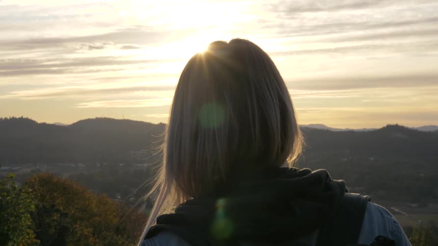 Woman looks out over a valley