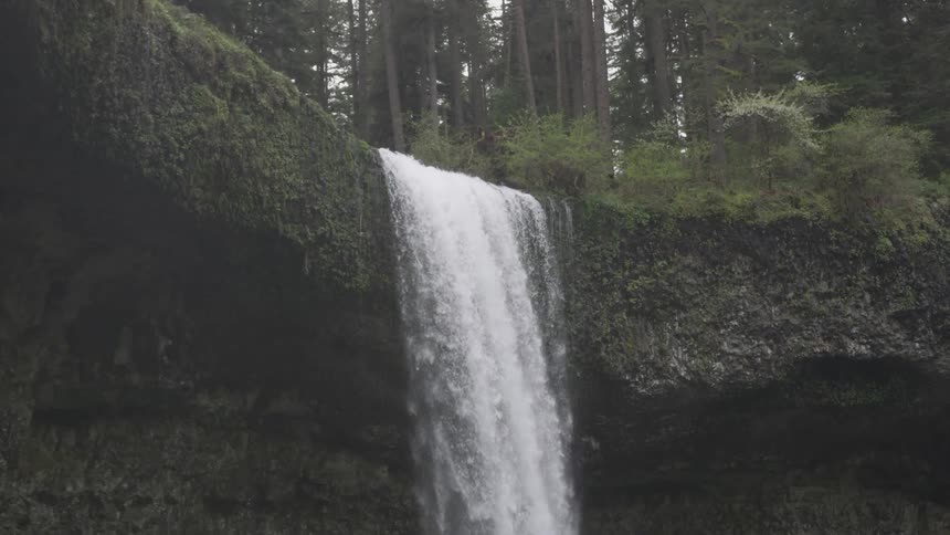 Water flows over the cliff in the forest