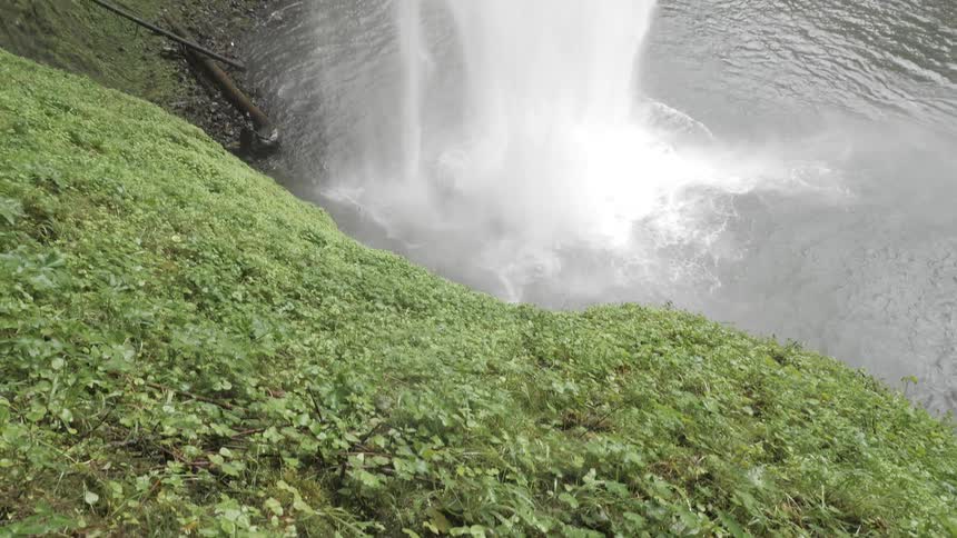 Camera looks down towards a waterfall