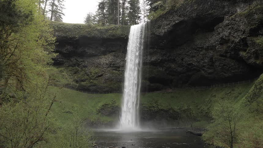 Water is falling from a waterfall into a river