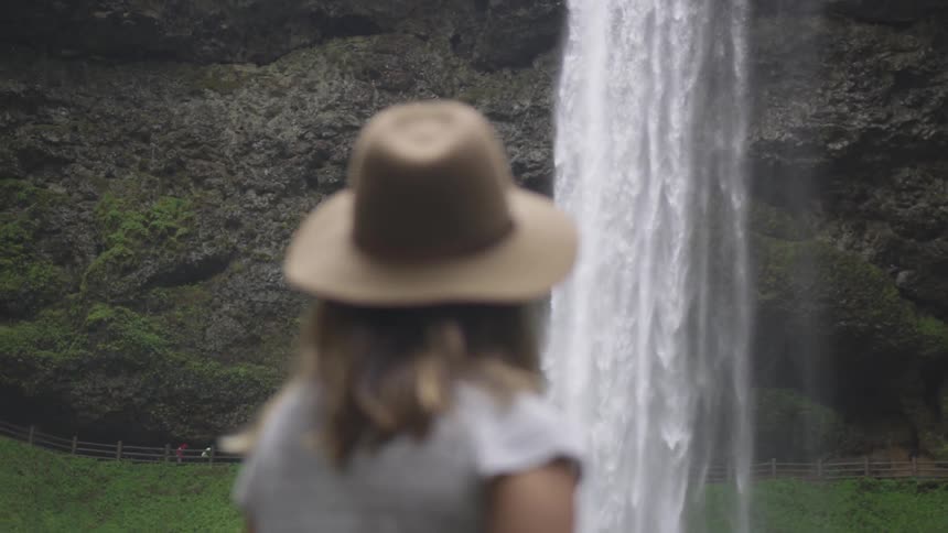 Woman looking at a waterfall