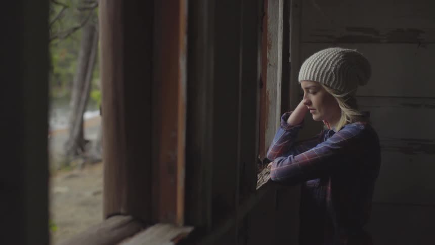 Woman looking through a window