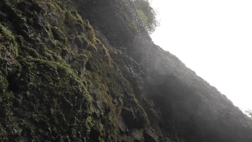 Water comes down towards the camera from a waterfall