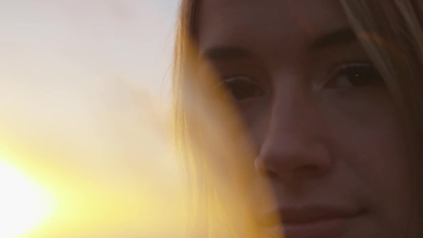A woman stares at the camera