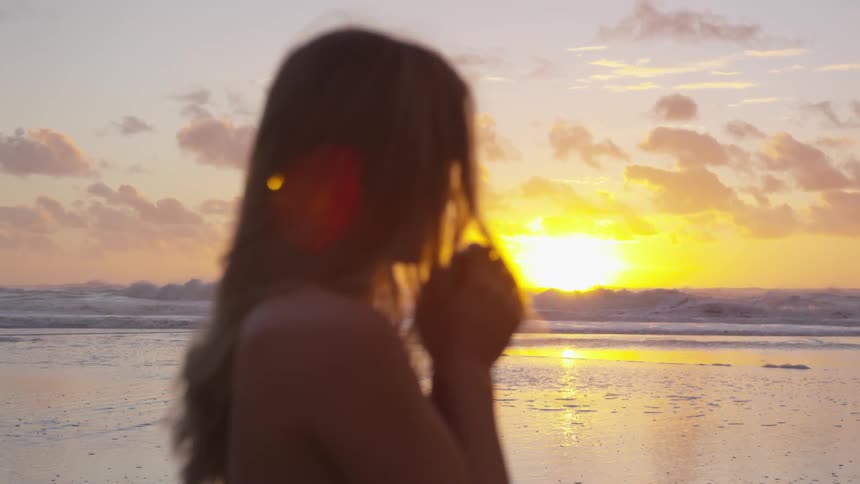 A woman looking towards the sunset