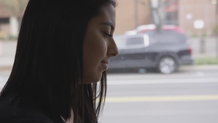 A woman standing outside smiling
