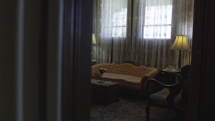 Light enters through the windows of the dim room in the daytime