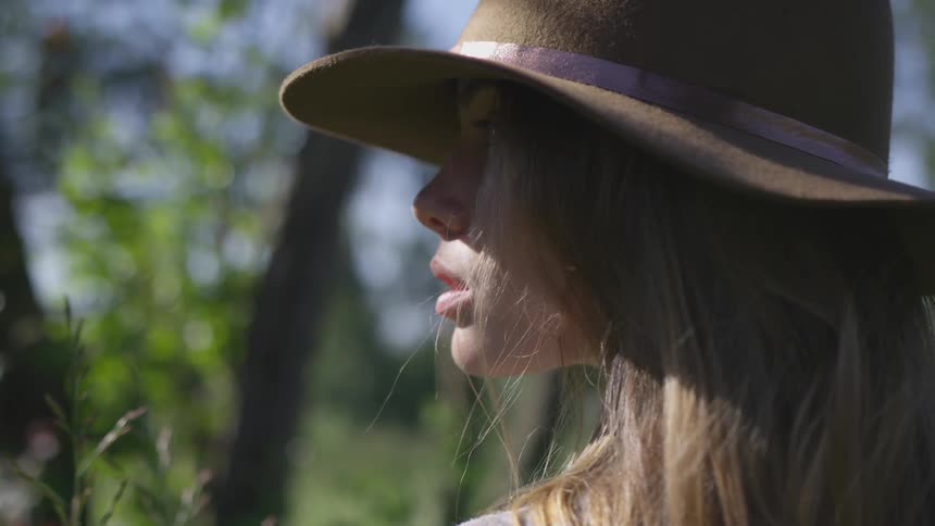 Young woman in hat outdoors in daytime