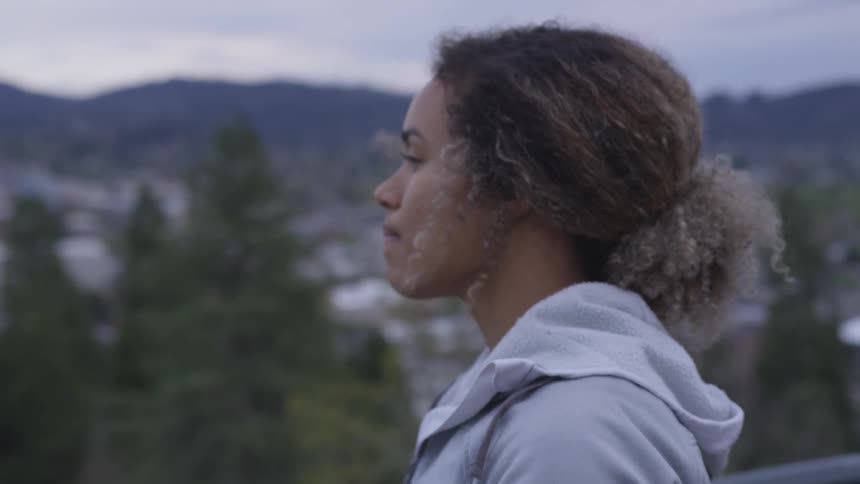 A person looks out over a city