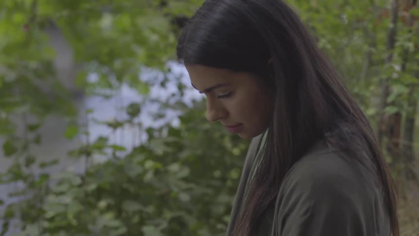 A woman stares downward