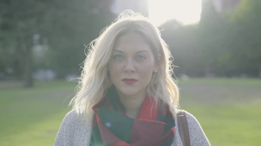 A blonde woman looking into the camera