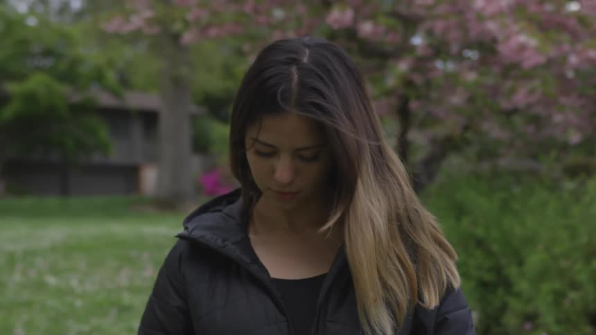 Girl looking down with hair blowing in the wind